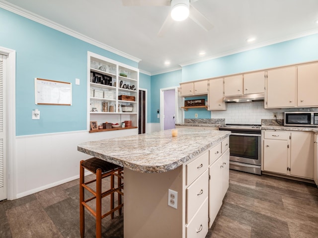 154 Montgomery Blvd, New Concord, OH 43762 - kitchen featuring stainless steel appliances, under cabinet range hood, light countertops, ornamental molding, and a kitchen island