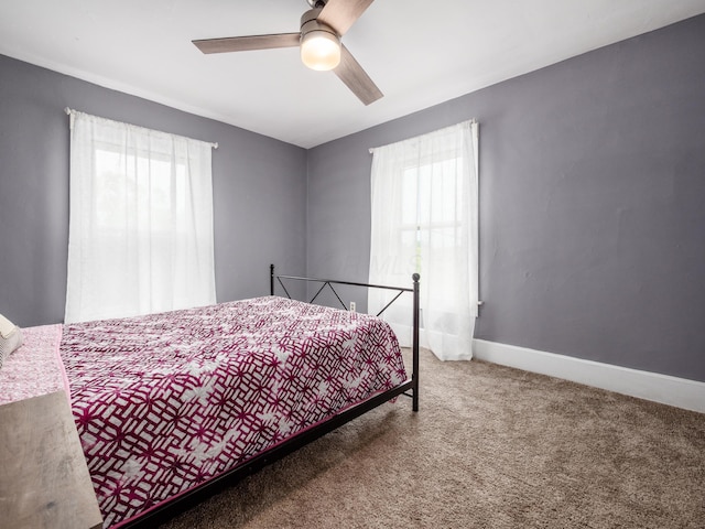 154 Montgomery Blvd, New Concord, OH 43762 - carpeted bedroom with multiple windows, ceiling fan, and baseboards