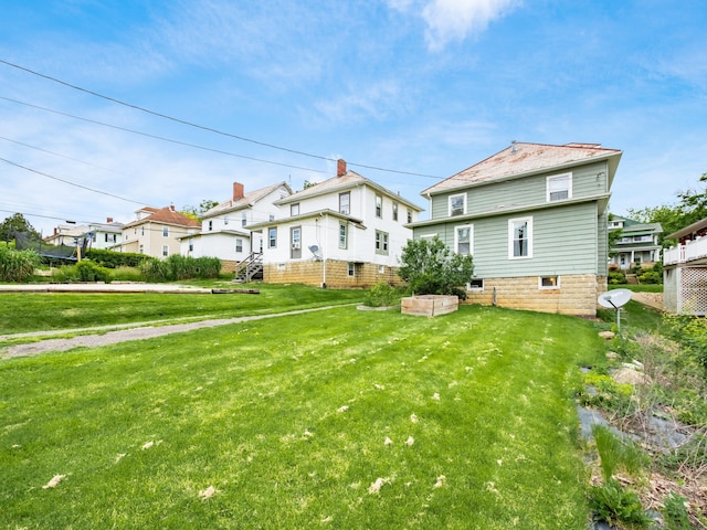 154 Montgomery Blvd, New Concord, OH 43762 - back of house featuring a yard
