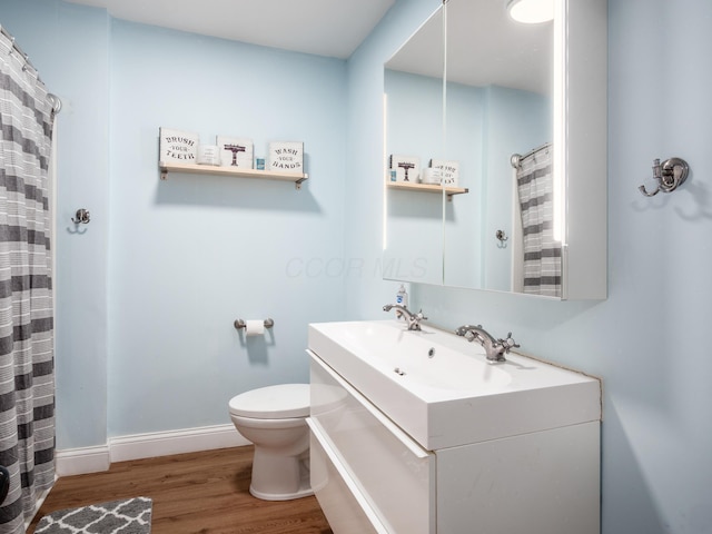 154 Montgomery Blvd, New Concord, OH 43762 - bathroom featuring toilet, wood finished floors, vanity, and baseboards