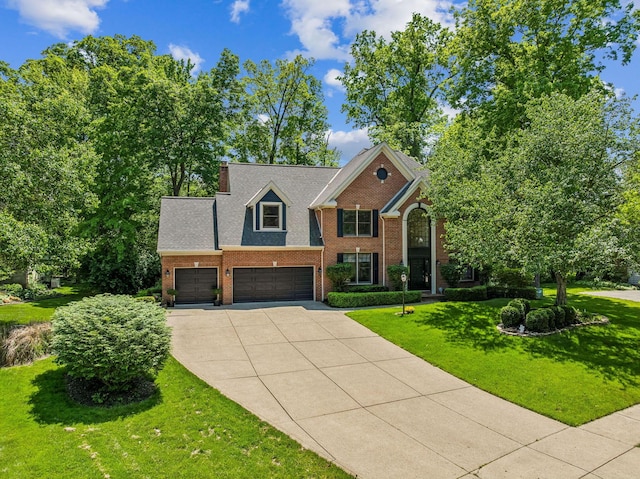 1229 Whispering Meadow Ct, New Albany, OH 43054 - view of front of house with brick siding, driveway, a front yard, and a garage