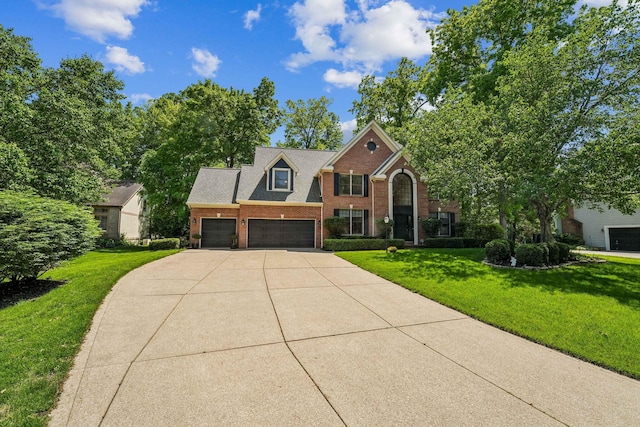 1229 Whispering Meadow Ct, New Albany, OH 43054 - view of front of property with driveway, brick siding, a front yard, and a garage