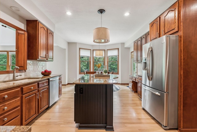 1229 Whispering Meadow Ct, New Albany, OH 43054 - kitchen with appliances with stainless steel finishes, a center island, light wood-style floors, healthy amount of natural light, and recessed lighting