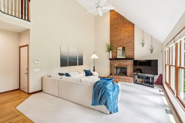 1229 Whispering Meadow Ct, New Albany, OH 43054 - living room with high vaulted ceiling, a fireplace, wood finished floors, and ceiling fan