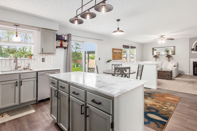 2535 Linbaugh Rd, Grove City, OH 43123 - kitchen featuring dishwasher, a sink, gray cabinetry, backsplash, and a textured ceiling