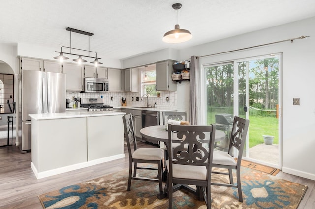 2535 Linbaugh Rd, Grove City, OH 43123 - dining room featuring wood finished floors, a textured ceiling, baseboards, and arched walkways