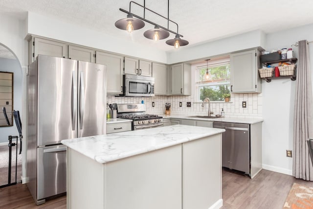 2535 Linbaugh Rd, Grove City, OH 43123 - kitchen featuring appliances with stainless steel finishes, a sink, gray cabinetry, light wood-style floors, and a textured ceiling