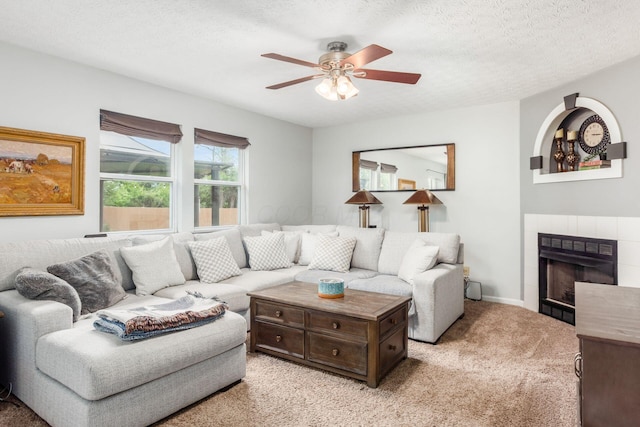 2535 Linbaugh Rd, Grove City, OH 43123 - living area featuring a tile fireplace, light colored carpet, a ceiling fan, and a textured ceiling