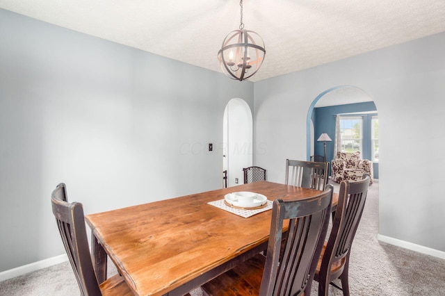 2535 Linbaugh Rd, Grove City, OH 43123 - dining area with arched walkways, a chandelier, light colored carpet, baseboards, and a textured ceiling