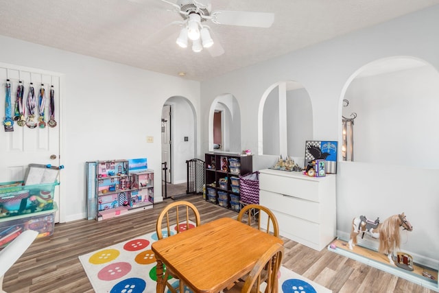 2535 Linbaugh Rd, Grove City, OH 43123 - dining space with wood finished floors, a ceiling fan, a textured ceiling, and arched walkways
