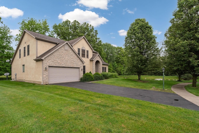 7415 Sand Spurrey Ct, Westerville, OH 43082 - view of front of property with stucco siding, stone siding, driveway, a front lawn, and a garage