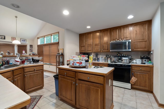 7415 Sand Spurrey Ct, Westerville, OH 43082 - kitchen featuring stainless steel microwave, electric range oven, brown cabinets, light countertops, and backsplash