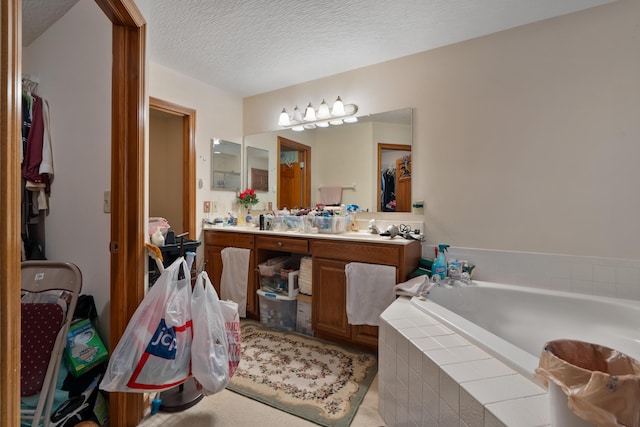 7415 Sand Spurrey Ct, Westerville, OH 43082 - full bath with a garden tub, vanity, a textured ceiling, and a closet