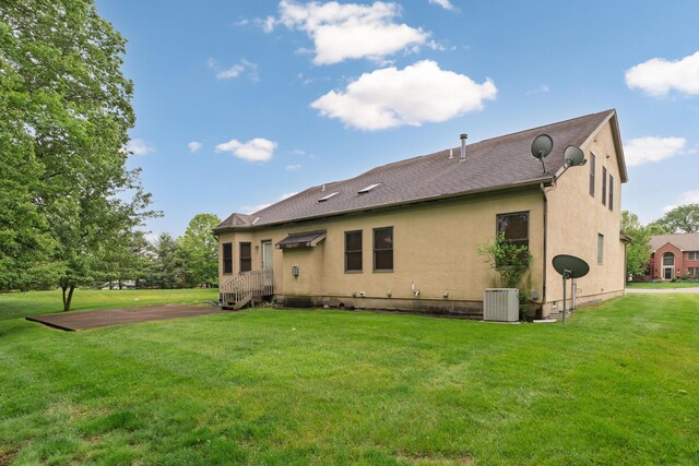 7415 Sand Spurrey Ct, Westerville, OH 43082 - rear view of property featuring central AC, a yard, and stucco siding