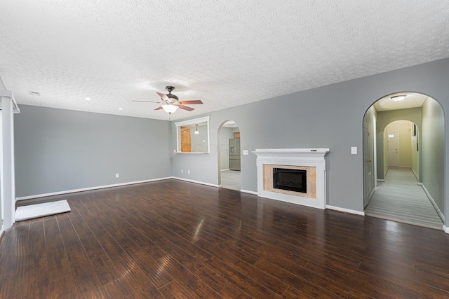 5924 Morrissey St Unit 5924E, Columbus, OH 43232 - unfurnished living room with ceiling fan, a textured ceiling, hardwood / wood-style flooring, a fireplace, and baseboards