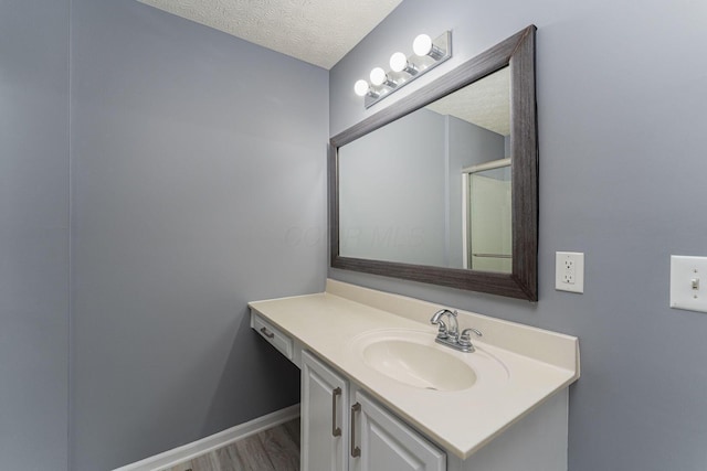 5924 Morrissey St Unit 5924E, Columbus, OH 43232 - bathroom with vanity, a textured ceiling, wood finished floors, and baseboards