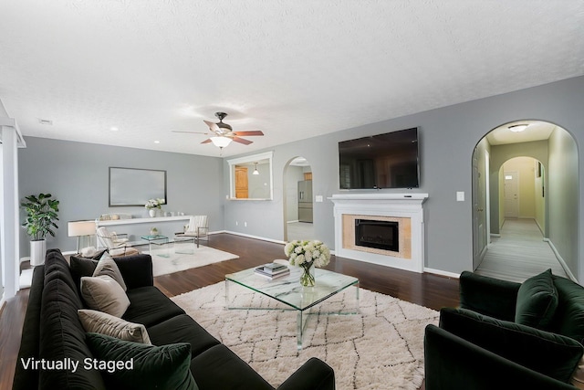 5924 Morrissey St Unit 5924E, Columbus, OH 43232 - living area with arched walkways, a ceiling fan, wood finished floors, baseboards, and a textured ceiling