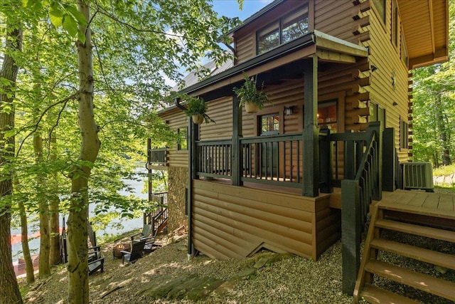 653 Natchez Ln, Sugar Grove, OH 43155 - view of side of home with cooling unit, log exterior, stairway, and a water view