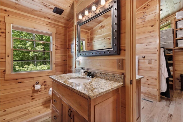 653 Natchez Ln, Sugar Grove, OH 43155 - bathroom featuring vanity, wood finished floors, toilet, wooden walls, and lofted ceiling