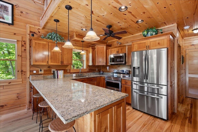 653 Natchez Ln, Sugar Grove, OH 43155 - kitchen featuring stainless steel appliances, a sink, light wood finished floors, a peninsula, and wood ceiling