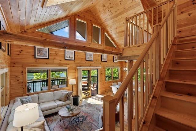 653 Natchez Ln, Sugar Grove, OH 43155 - living room featuring wooden walls, stairway, wood ceiling, and high vaulted ceiling