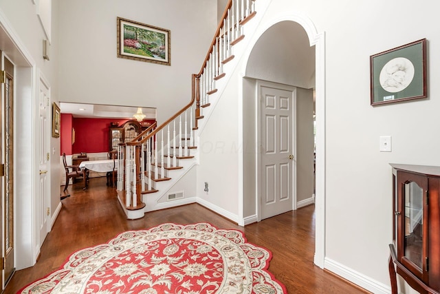 5360 Smothers Rd, Westerville, OH 43081 - foyer entrance with wood finished floors, stairway, baseboards, a towering ceiling, and arched walkways