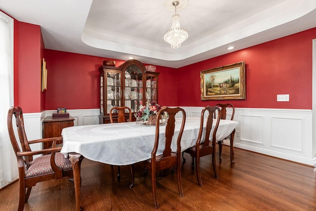 5360 Smothers Rd, Westerville, OH 43081 - dining space featuring a chandelier, wood finished floors, a tray ceiling, a wainscoted wall, and a decorative wall