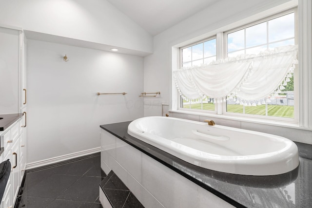 5360 Smothers Rd, Westerville, OH 43081 - bathroom featuring lofted ceiling, a garden tub, and plenty of natural light