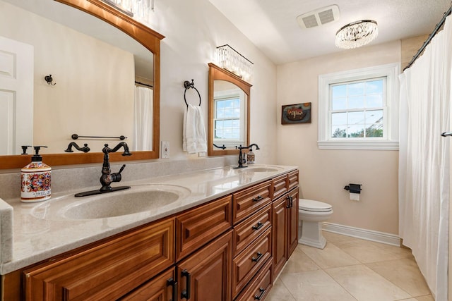 5360 Smothers Rd, Westerville, OH 43081 - bathroom featuring double vanity, toilet, tile patterned flooring, and baseboards