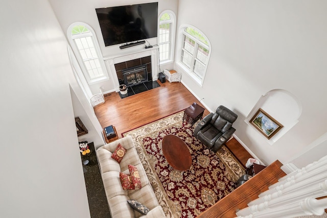 5360 Smothers Rd, Westerville, OH 43081 - living room with healthy amount of natural light, a high ceiling, wood finished floors, a fireplace, and baseboards
