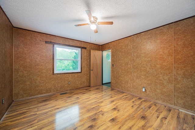 1959 Chapel Creek Rd, Chillicothe, OH 45601 - spare room featuring wood finished floors, ceiling fan, a textured ceiling, and ornamental molding