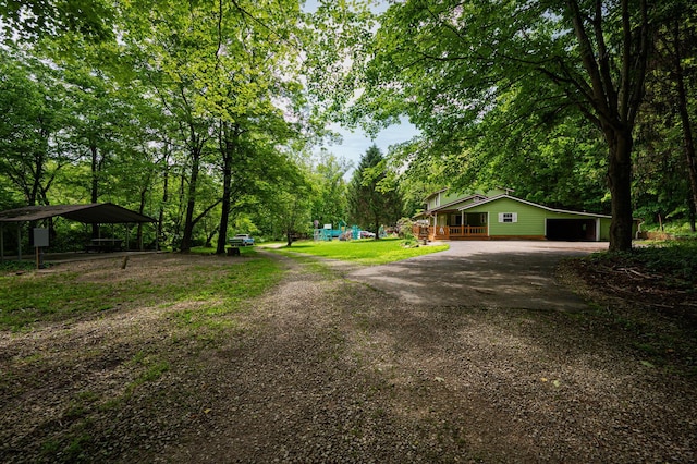 1959 Chapel Creek Rd, Chillicothe, OH 45601 - view of yard with driveway, a porch, and view of wooded area