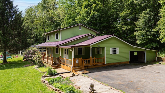 1959 Chapel Creek Rd, Chillicothe, OH 45601 - view of front of house with driveway, a porch, a front lawn, and metal roof