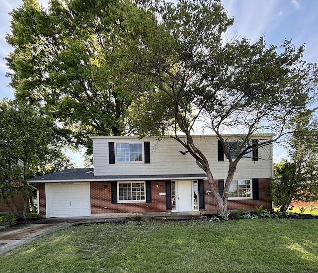 1419 Hentz Dr, Reynoldsburg, OH 43068 - traditional home with brick siding, driveway, an attached garage, and a front lawn