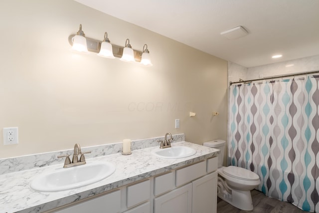 1419 Hentz Dr, Reynoldsburg, OH 43068 - full bathroom featuring toilet, wood finished floors, a shower with shower curtain, and double vanity
