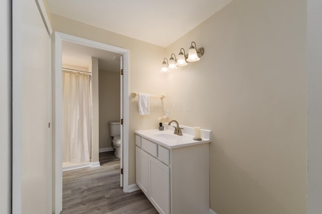 1419 Hentz Dr, Reynoldsburg, OH 43068 - bathroom with toilet, vanity, wood finished floors, baseboards, and curtained shower