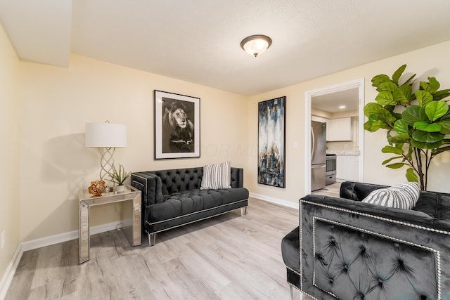 1419 Hentz Dr, Reynoldsburg, OH 43068 - living room with light wood-style floors and baseboards