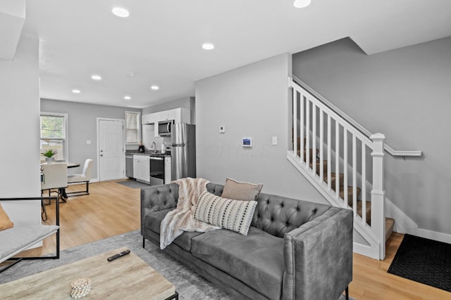 369 S 17th St, Columbus, OH 43205 - living room featuring light wood-type flooring, stairway, recessed lighting, and baseboards