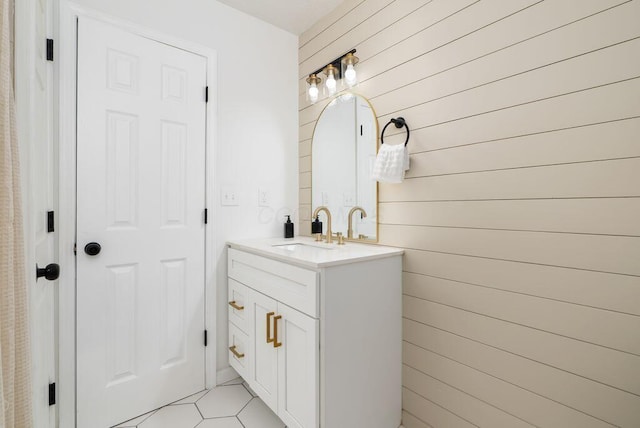 215 Stockbridge Rd, Columbus, OH 43207 - bathroom with vanity, wooden walls, and tile patterned floors