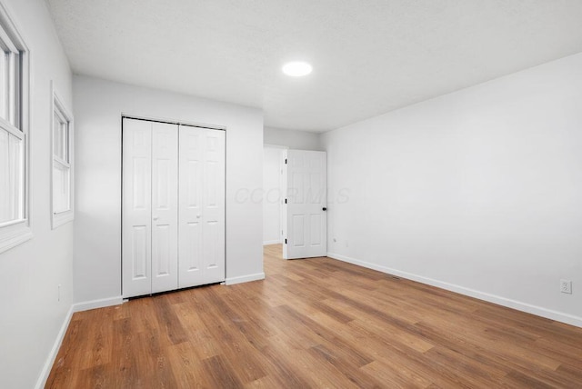 215 Stockbridge Rd, Columbus, OH 43207 - unfurnished bedroom featuring baseboards, wood finished floors, a closet, and recessed lighting