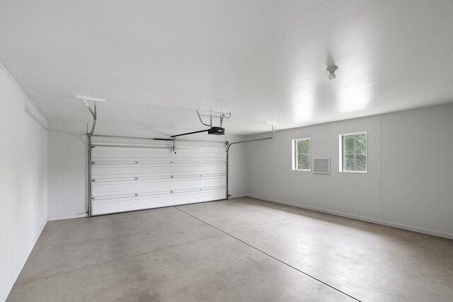 215 Stockbridge Rd, Columbus, OH 43207 - garage with a garage door opener and baseboards
