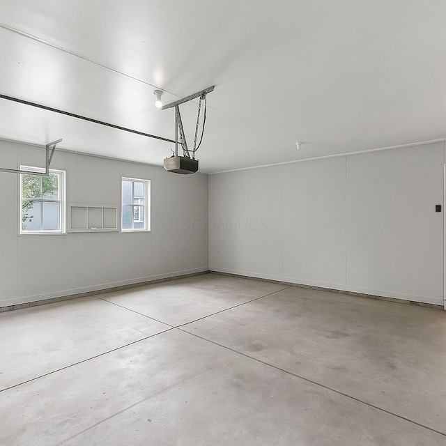 215 Stockbridge Rd, Columbus, OH 43207 - garage featuring a garage door opener and baseboards