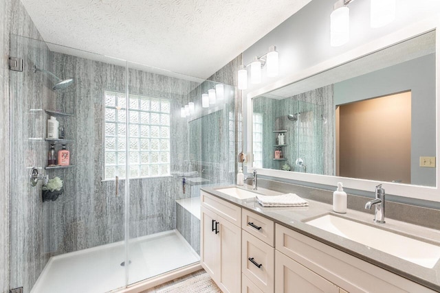 2643 Westrock Dr, Hilliard, OH 43026 - bathroom with a shower stall, double vanity, and a textured ceiling