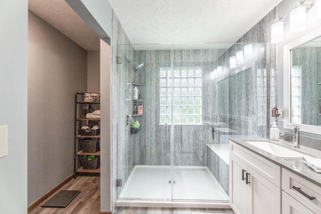 2643 Westrock Dr, Hilliard, OH 43026 - full bathroom featuring vanity, a shower stall, a textured ceiling, and wood finished floors