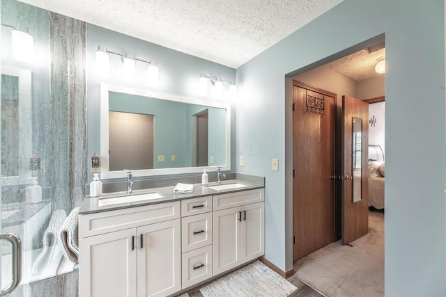 2643 Westrock Dr, Hilliard, OH 43026 - full bath featuring double vanity, a textured ceiling, and connected bathroom
