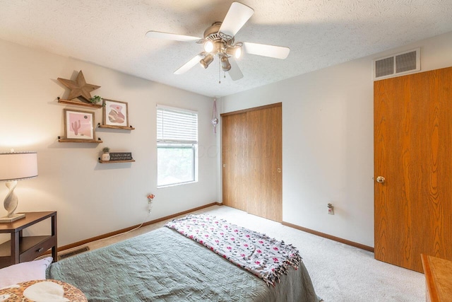 2643 Westrock Dr, Hilliard, OH 43026 - carpeted bedroom featuring a closet, a textured ceiling, baseboards, and a ceiling fan