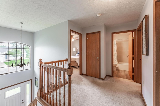 2643 Westrock Dr, Hilliard, OH 43026 - hall with an upstairs landing, carpet flooring, a textured ceiling, and baseboards
