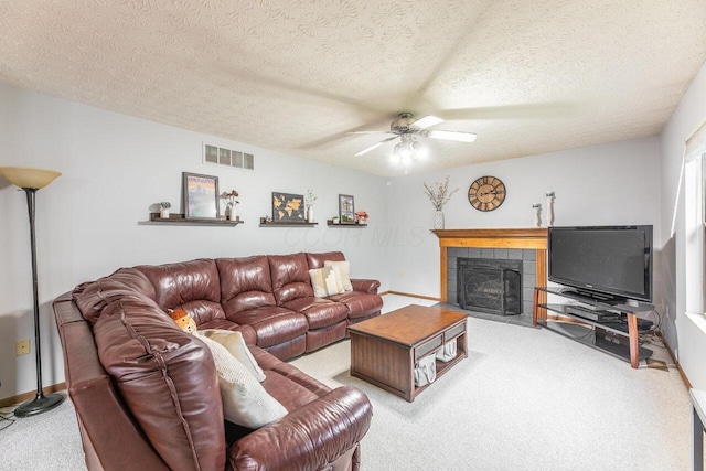 2643 Westrock Dr, Hilliard, OH 43026 - carpeted living area with a fireplace, a ceiling fan, a textured ceiling, and baseboards