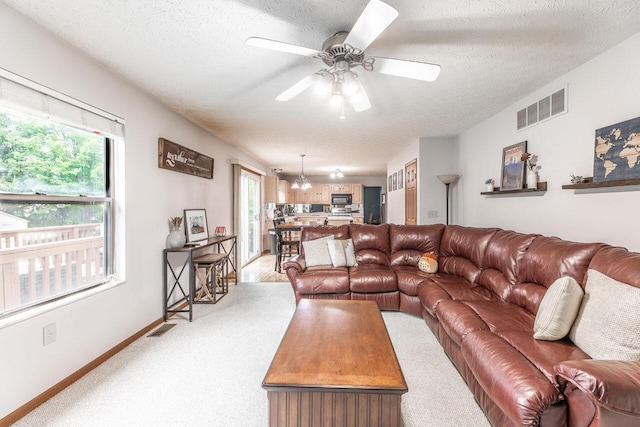 2643 Westrock Dr, Hilliard, OH 43026 - living area with a ceiling fan, a textured ceiling, light colored carpet, and baseboards