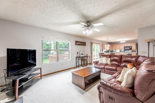 2643 Westrock Dr, Hilliard, OH 43026 - living room featuring a ceiling fan, light carpet, baseboards, and a textured ceiling